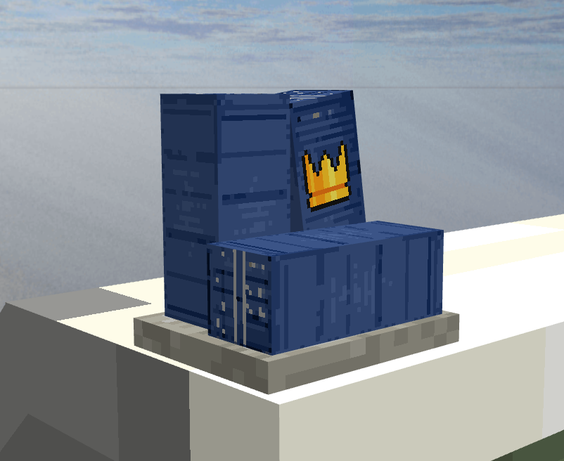 The Construction trophy: stacked blue shipping containers on a stone plinth, one marked with a gold crown